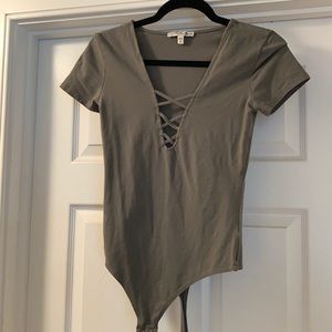 Green body suit with lace up detailing